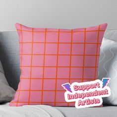 an orange and pink pillow with the words support independent artists on it