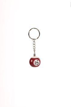 a keychain with a ball and number fifteen on it