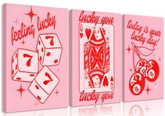 three pink playing cards with red lettering and dices on the front, one in white