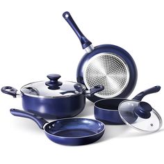 an assortment of blue pots and pans on a white background, with one empty frying pan in the middle