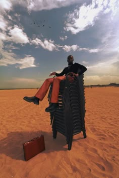 a man sitting on top of a bench in the desert