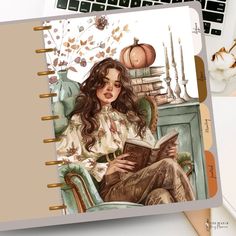 a notebook with a drawing of a woman sitting in a chair and reading a book