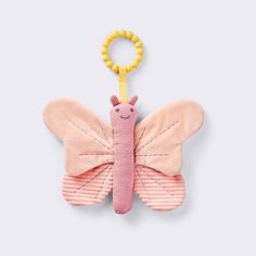 a pink and yellow butterfly toy hanging from a hook