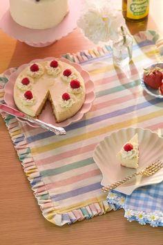 a table topped with plates and cakes covered in frosting