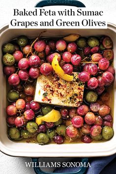 baked feta with sumac grapes and green olives in a casserole dish