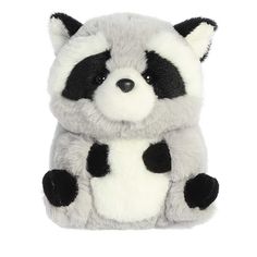 a stuffed raccoon sitting on top of a white surface