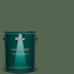 the behr marquee paint is shown in an open, green tint