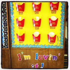 a mcdonald's vending machine is decorated with paper cups and the words i'm lovin