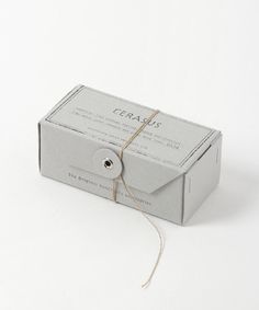 a gray box tied up with twine and some string on the side that says cera's