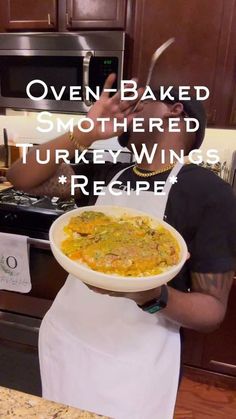 a man is holding a bowl of food in front of his face with the words oven baked smothered turkey wings recipe