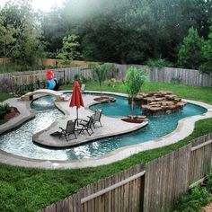 a backyard with a pool and fire pit