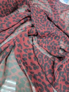 a red and black animal print fabric