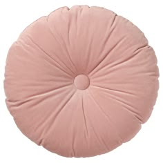 a pink round pillow on a white background