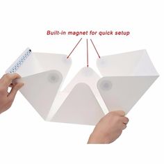 two pieces of white paper being held by hands