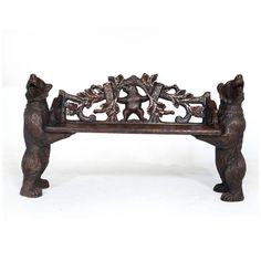 an ornate wooden bench with bears on it's back and arms, sitting against a white background