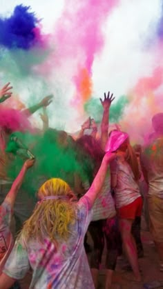 people are throwing colored powder at each other