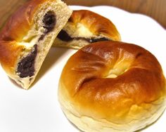 two bagels sitting on top of a white plate