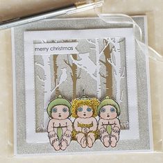 a christmas card with two babies in the woods