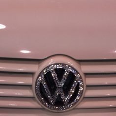 the front grille of a white vw car with diamonds on it's grill