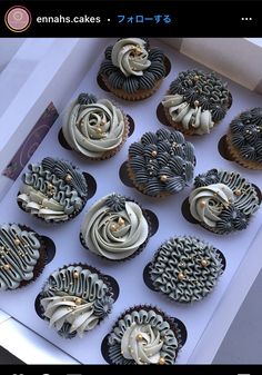 a box filled with lots of cupcakes covered in frosting