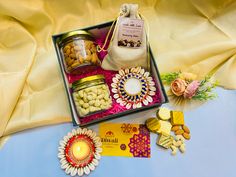 a box filled with assorted food items on top of a blue cloth covered table