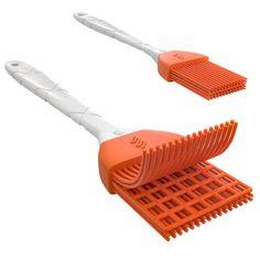 two orange and white combs sitting next to each other