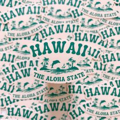 the hawaii state sticker is on top of a pile of green and white stickers