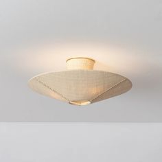 a ceiling light with a white shade on it