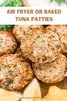 air fryer or baked tuna patties on a cutting board with lemon wedges and parsley