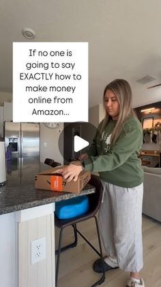 a woman standing in front of a kitchen counter opening a box with an amazon logo on it