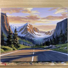 an oil painting of a mountain road with trees and mountains in the background at sunset