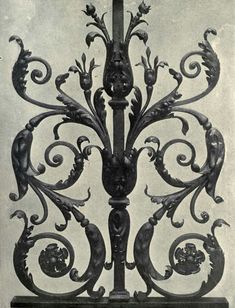 an ornate iron work on the side of a building