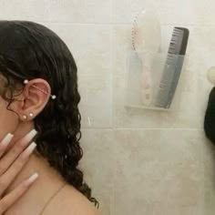 a woman with her hands on her face in front of a hair dryer and comb