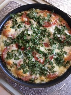 a pizza sitting on top of a pan covered in cheese and vegtables