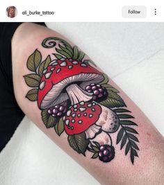 a mushroom and berries tattoo on the arm