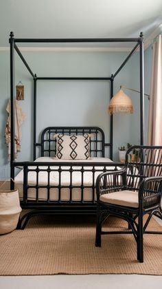 a bedroom with a canopy bed and wicker chairs in it, along with a rug on the floor