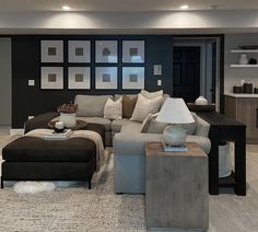 a living room filled with furniture and pictures on the wall