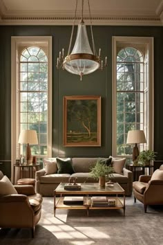 a living room filled with lots of furniture and large windows in the wall behind them