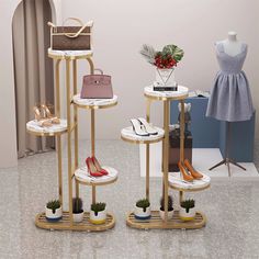 three tiered display stands with shoes and purses on them in front of a mannequin