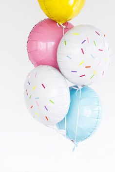 a bunch of balloons that have sprinkles on them