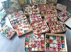 several boxes filled with ornaments on top of a wooden table