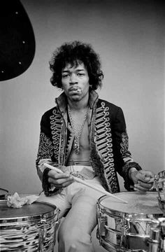 a man sitting on top of a drum set