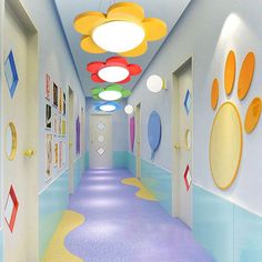 the hallway is painted in bright colors and has colorful circles on the ceiling above it