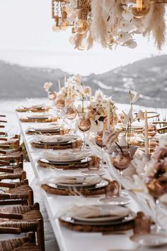 a long table is set with plates and place settings