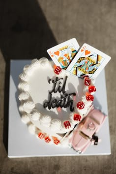 a birthday cake with cards and dice on it