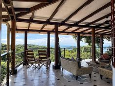 a living room filled with furniture on top of a tiled floor next to a balcony