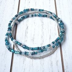 This bracelet set is a gorgeous combo of teal and silver. Hints of crystals throughout make it sparkle in the light.  You will receive 3 bracelets in this set. Mix n match with my other bracelets for endless styles! Each piece is handmade with: - High Quality Glass Seed Beads - Faceted Crystals - Stretch Cord: High-quality cord with reinforced knots Easily layer with other Luna by Rachel bracelets for a stunning stack! My pieces are made sturdy, but as with all jewelry, they are also delicate and should be treated with care. Be sure to check out other designs in my shop at http://etsy.com/shop/lunabyrachel  Thank you for shopping Luna by Rachel ~ Unique Jewelry for Unique Individuals Tiny Bead Bracelet, Teal And Silver, Small Bead Bracelet, Stackable Bracelets, Bead Bracelets, Faceted Crystal, Bracelet Stack, Mix N Match, Bead Bracelet