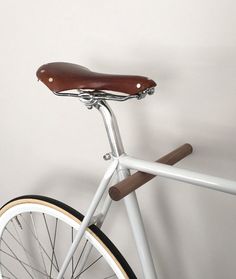 a close up of a bike with a wooden seat