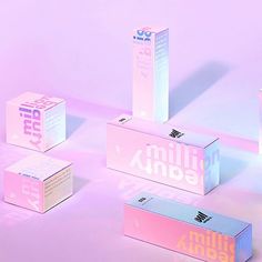 four boxes with different logos on them sitting on a pink and blue surface, one is empty