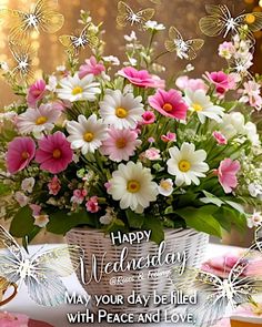 a basket filled with lots of flowers on top of a table next to a cake